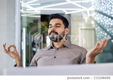 Businessman practicing mindfulness meditation in a modern office space, promoting mental well-being and stress relief 115206000