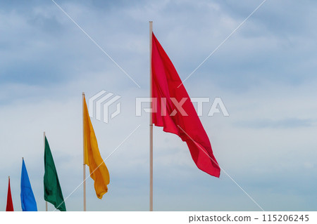 Flags of different colors stretching into the horizon, decoration of beaches and other tourist areas on the eve of the opening of the tourist season and receiving guests from abroad, hospitality 115206245