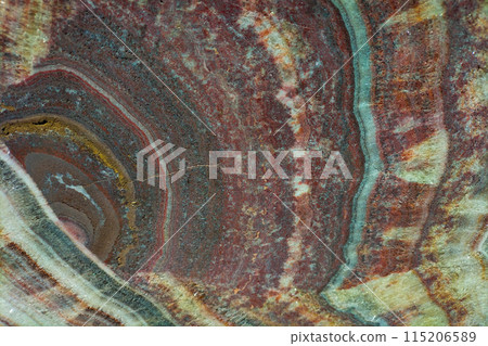 Surprisingly colorful layers in the structure of a piece of ancient marble, a variety of patterns, growths that have formed over a long time. Screensaver background, wallpaper Surprisingly colorful layers in the structure of a piece of ancient marble, a variety of patterns, growths that have formed over a long time. Screensaver background, wallpaper 115206589