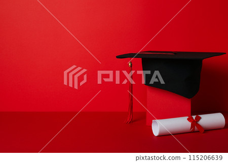 Graduate hat with diploma on red background. 115206639