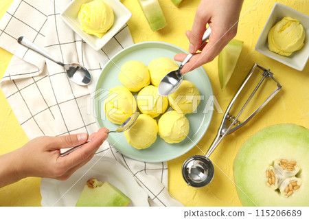 Ice cream scoops in a bowl with slices of fresh melon 115206689