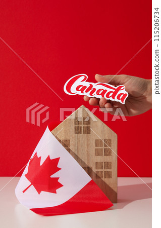 A wooden house with the flag of Canada 115206734