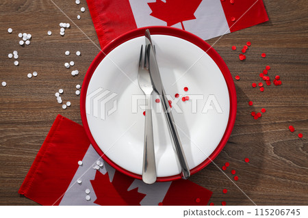 Cutlery with flag of Canada on wooden background Cutlery with flag of Canada on wooden background 115206745