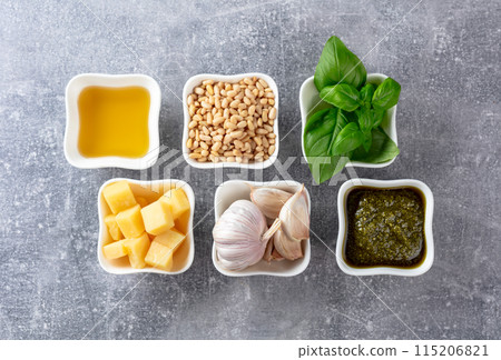 Traditional Italian pesto recipe on a grey stone background. Traditional Italian pesto recipe on a grey stone background. 115206821