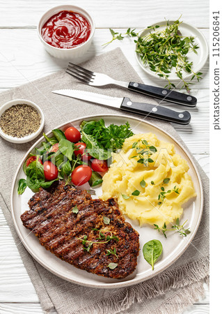 grilled pork steak with mashed potato and salad 115206841