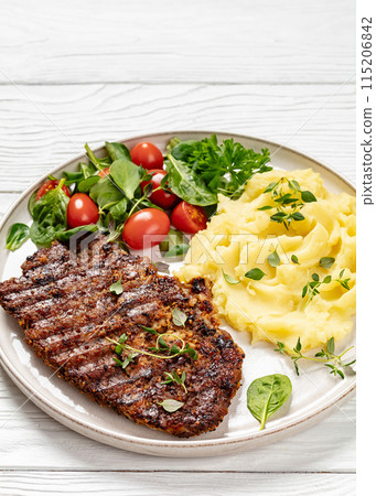 grilled pork steak with mashed potato and salad 115206842