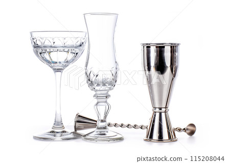 Bartender Stainless steel jigger, bar spoon and glasses isolated on white background 115208044