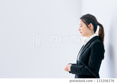 A business woman looking down a little 115208176