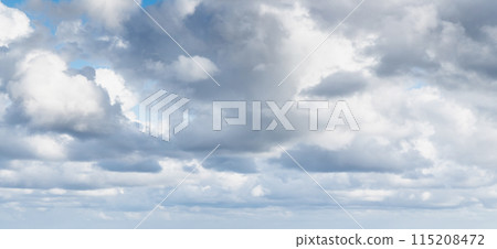 White cumulus clouds are in blue sky on a summer day, panorama 115208472