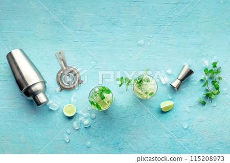 Mojito cocktail. Summer cold drink with lime, fresh mint, and ice. Cool beverage Mojito cocktail. Summer cold drink with lime, fresh mint, and ice. Cool beverage 115208973