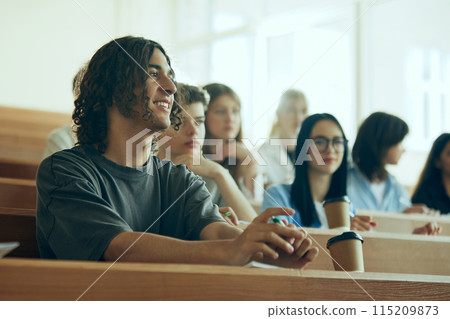 Young students, boys and girls sitting in university auditorium and listening to lecture. Growing future and learning profession 115209873