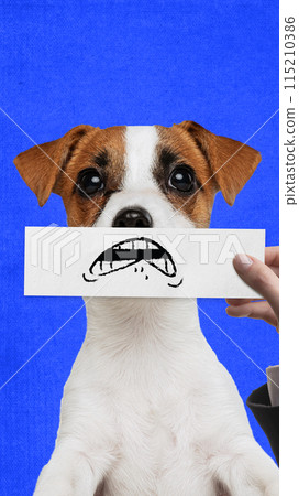 Shocked muzzle. Purebred dog against blue background, with human hand holding drawn cartoonish eyes. Creative collage. 115210386