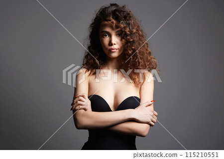 beautiful young woman with curly hair. pretty sexy girl 115210551