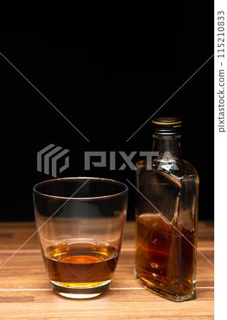 Whiskey bottle and glass (vertical composition) Whiskey bottle and glass (vertical composition) 115210833