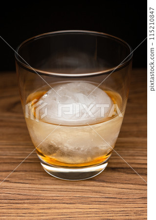 Whisky on the rocks with round ice (vertical composition) Whisky on the rocks with round ice (vertical composition) 115210847