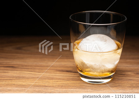 Whisky on the rocks with round ice cubes 115210851