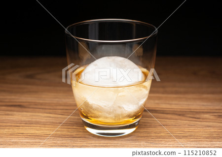 Whisky on the rocks with round ice cubes 115210852