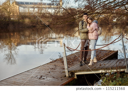 Embracing Moments: Beautiful 35-Year-Old Mother and 17-Year-Old Son in Winter or Autumn Park by Neckar River, Bietigheim-Bissingen, Germany Embracing Moments: Beautiful 35-Year-Old Mother and 17-Year-Old Son in Winter or Autumn Park by Neckar River, Bietigheim-Bissingen, Germany 115211568