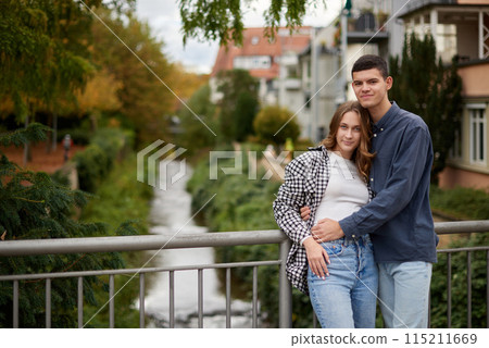 Warm Embrace of Teen Love in the Autumn Park. Capturing Teen Moments: Love Blossoms in Autumn's Embrace. Teenagers in Love: Embracing the Autumn Vibe 115211669