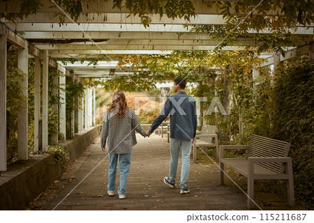 Warm Embrace of Teen Love in the Autumn Park. Capturing Teen Moments: Love Blossoms in Autumn's Embrace. Teenagers in Love: Embracing the Autumn Vibe 115211687
