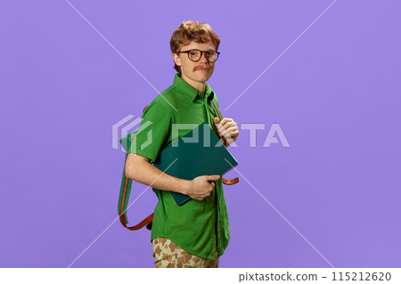 Portrait of young man, student dressed casual attire with backpack holding notebook against purple background. Portrait of young man, student dressed casual attire with backpack holding notebook against purple background. 115212620