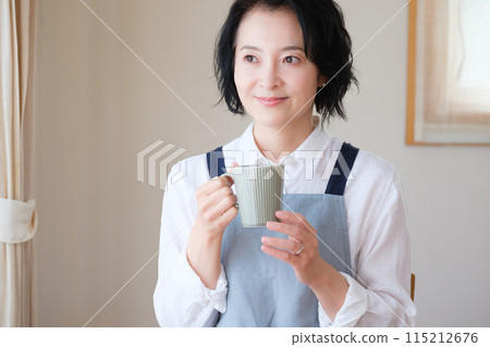 A middle-aged woman spending an afternoon in the living room 115212676