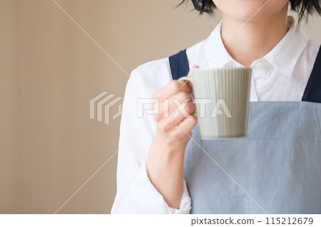 A middle-aged woman spending an afternoon in the living room A middle-aged woman spending an afternoon in the living room 115212679