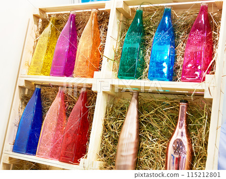 Colorful glass bottles in boxes Colorful glass bottles in boxes 115212801