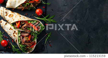 Gyros, shawarma wrapped in pita breads on black background. Take away street food. Two fresh sandwich rolls, burritos. Doner kebab, lettuce, tomatos, spice. Tortillas filling of vegetables, beef meat. 115213159
