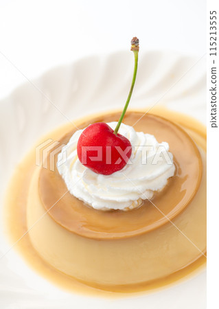 Custard pudding topped with cherries and fresh cream on a white background 115213555