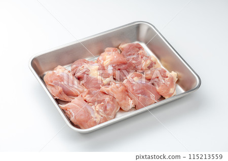 Raw chicken thighs in a cooking tray on a white background 115213559