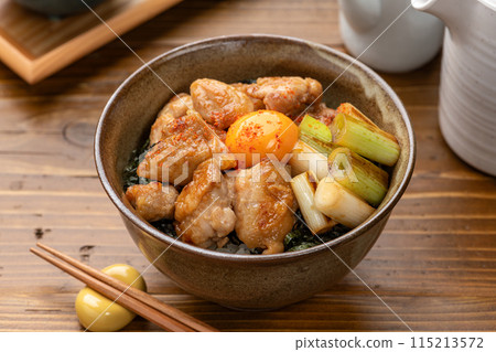 Yakitori rice bowl topped with egg yolk 115213572