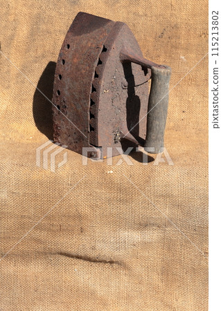 Rare iron working on coals. It stands on a coarse cloth. 115213802