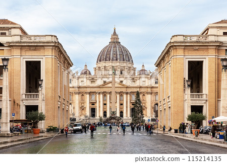 View of St. Peter's Basilica in the Vatican city against blue sky background, Rome, Italy. 115214135