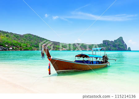 Thai traditional wooden longtail boat and beautiful sand beach at Koh Phi Phi island in Krabi province in Thailand. Thai traditional wooden longtail boat and beautiful sand beach at Koh Phi Phi island in Krabi province in Thailand. 115214136
