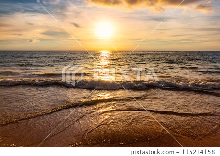 Amazing beautiful sunset with sea waves against a cloudy sky in Phuket, Thailand. 115214158