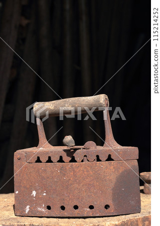 Rare iron working on coals. Located on a wooden deck. Rare iron working on coals. Located on a wooden deck. 115214252