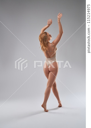 Graceful woman in underwear performing dance in studio Graceful woman in underwear performing dance in studio 115214975