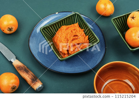 Loquat medlar fruit sauce on a table. 115215204