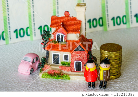 Scene with miniature toy figures, a young couple, residential house, a car, a pile of coins Scene with miniature toy figures, a young couple, residential house, a car, a pile of coins 115215382