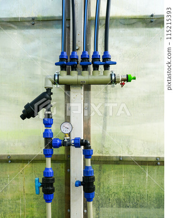 Place of connections of many plastic pipes system of greenhouse water supply with shut off valves 115215393
