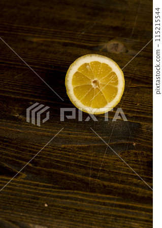 ripe sliced lemon on a board 115215544