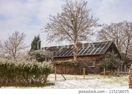 Winter Wonderland: Snow-Covered European Village Countryside. A Snow-Covered European Village in the Picturesque Countryside 115216075