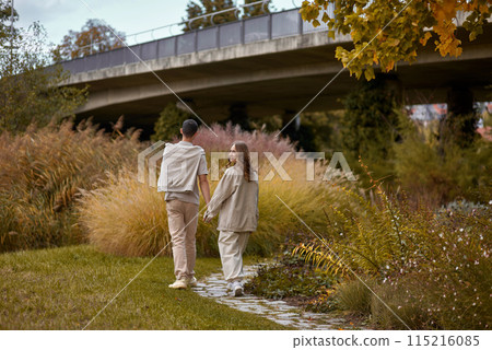 Warm Embrace of Teen Love in the Autumn Park. Capturing Teen Moments: Love Blossoms in Autumn's Embrace. Teenagers in Love: Embracing the Autumn Vibe 115216085