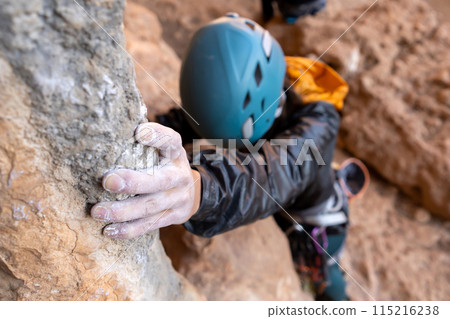 Girl is climbing on the rocks, closeup view on hand. Girl is climbing on the rocks, closeup view on hand. 115216238