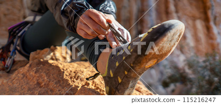 Girl is wearing climbing shoes, closeup view. 115216247