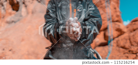Girl is climbing with magnesium powder on the rocks. 115216254