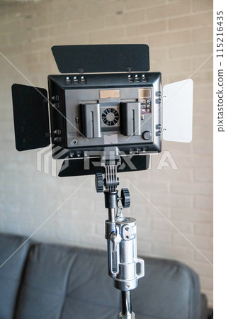 Rear view of a video lighting panel mounted on a tripod. LED flashlight,batteries 115216435