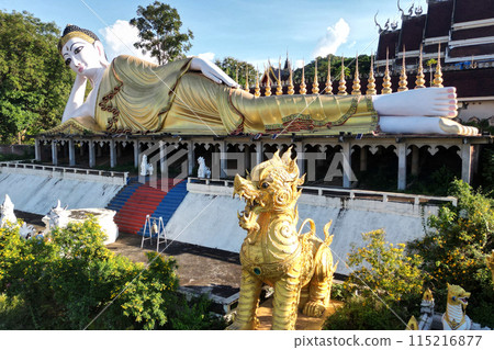 Top view of outdoor large Buddhist reclining Buddha at Wat Phra That Suthon Mongkhon Khiri Samakkhi Tham. 115216877
