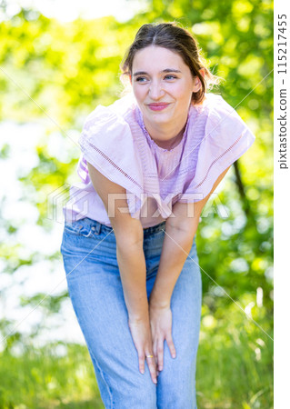 Young Woman Enjoying a Playful Moment in Nature Young Woman Enjoying a Playful Moment in Nature 115217455